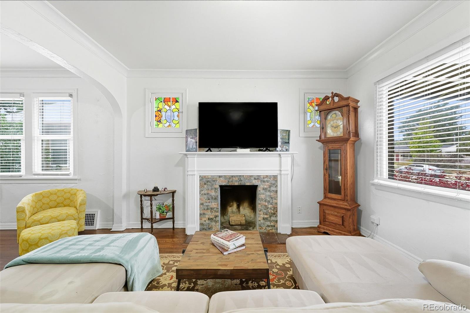 1280 Harrison Street Denver, CO 80206 - Photo 10 of 50 a living room with furniture a fireplace and a flat screen tv