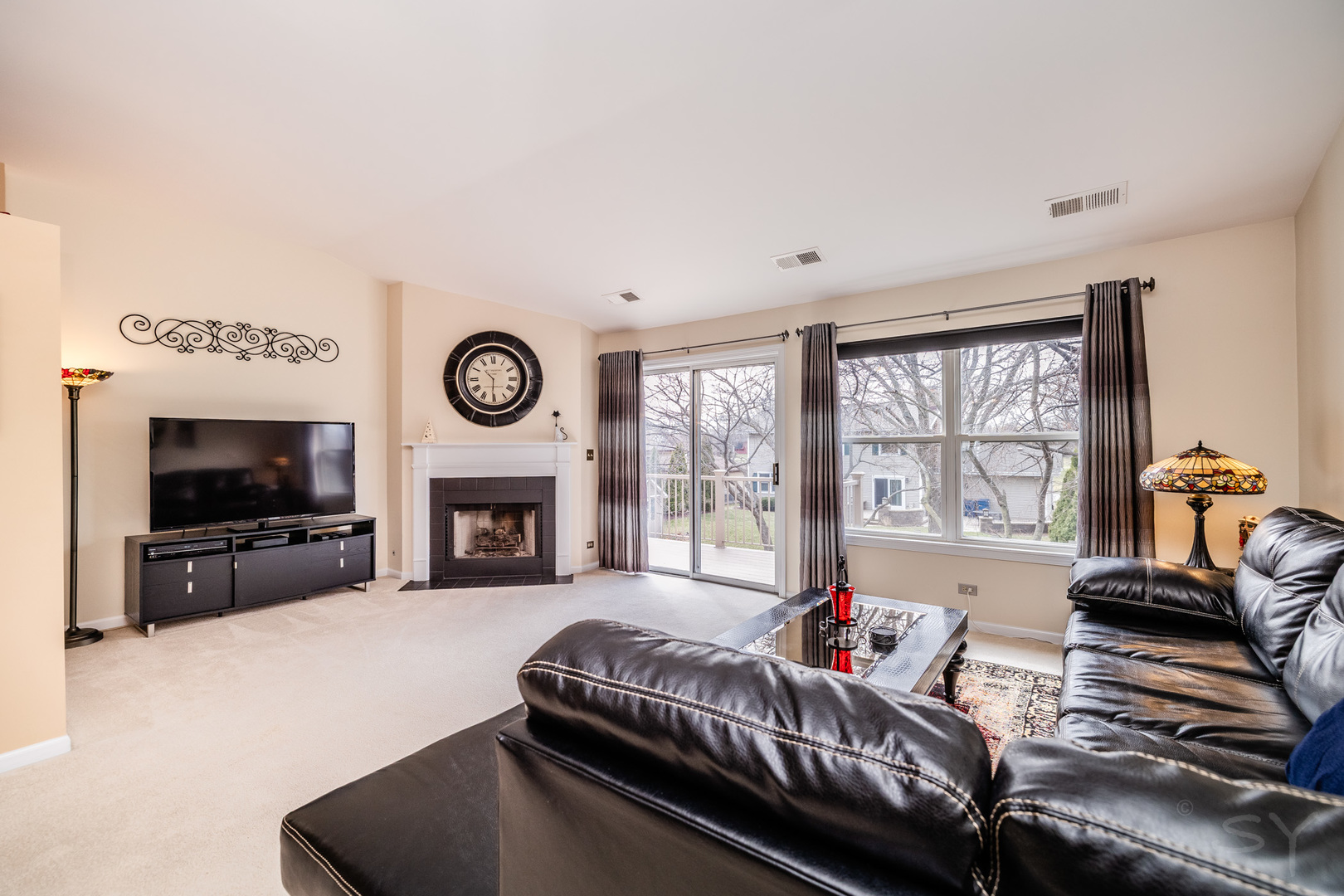 274 Wildspring Court Itasca, IL 60143 - Photo 11 of 42 a living room with furniture a fireplace and a flat screen tv