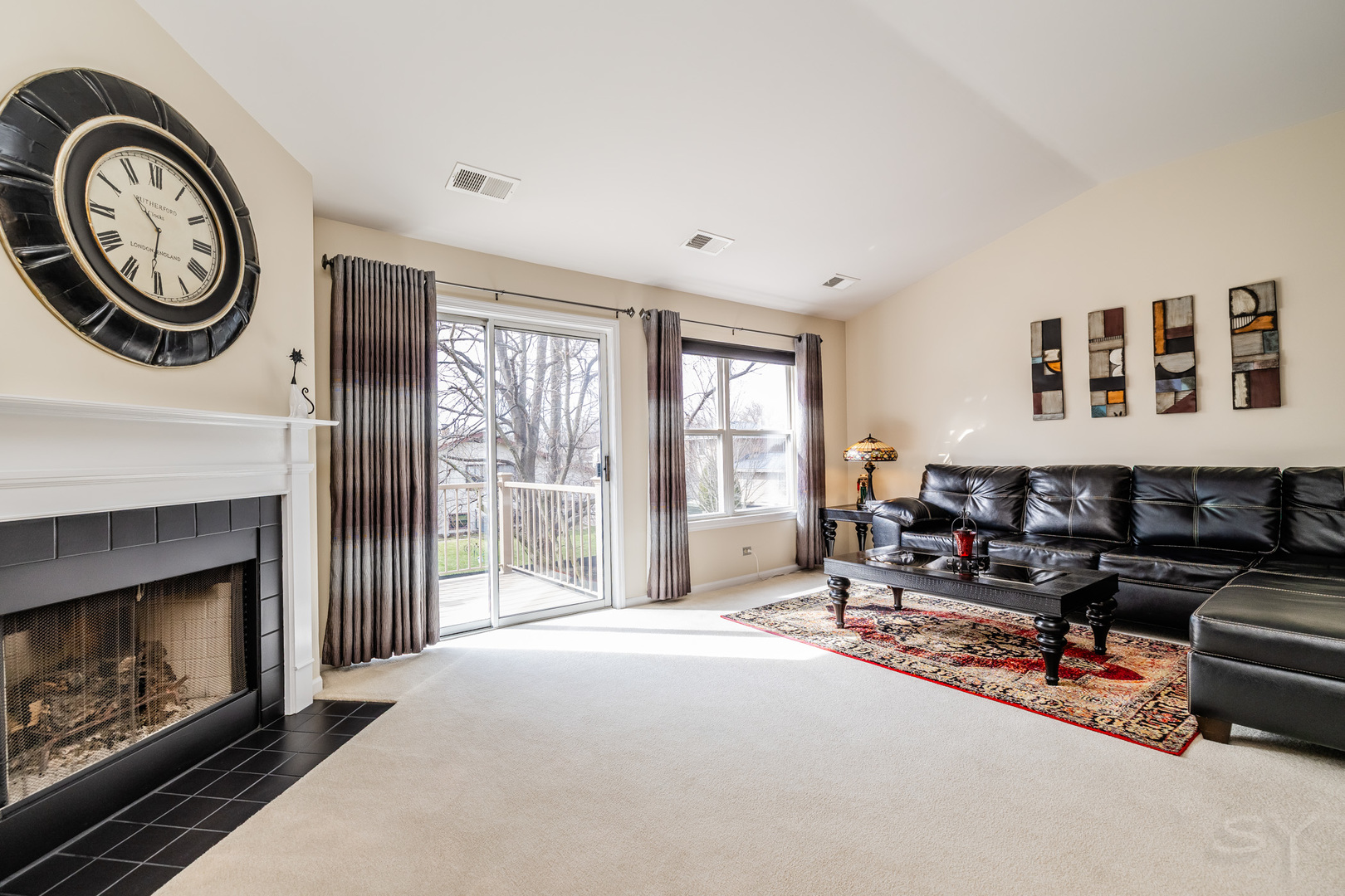 274 Wildspring Court Itasca, IL 60143 - Photo 15 of 42 a living room with furniture a clock and a fireplace