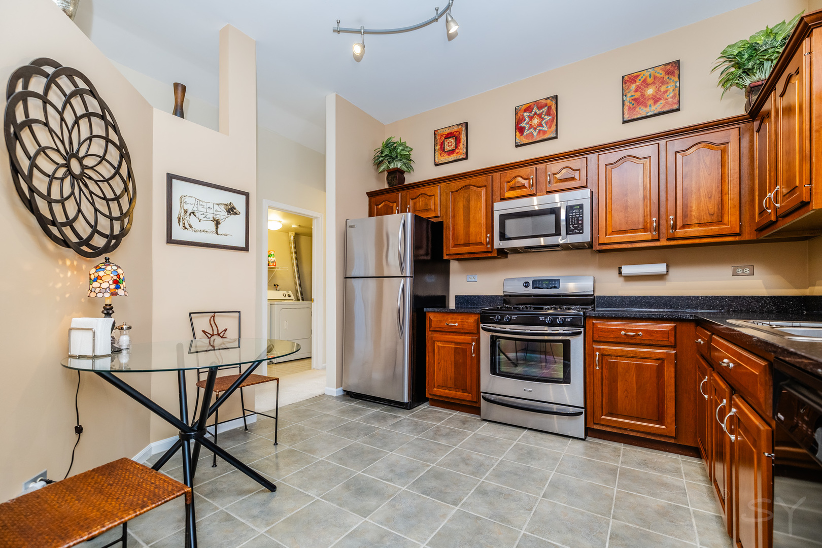 274 Wildspring Court Itasca, IL 60143 - Photo 18 of 42 a kitchen with stainless steel appliances granite countertop a refrigerator and a stove top oven