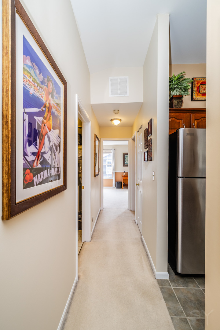 274 Wildspring Court Itasca, IL 60143 - Photo 30 of 42 a view of a hallway with wooden shelves