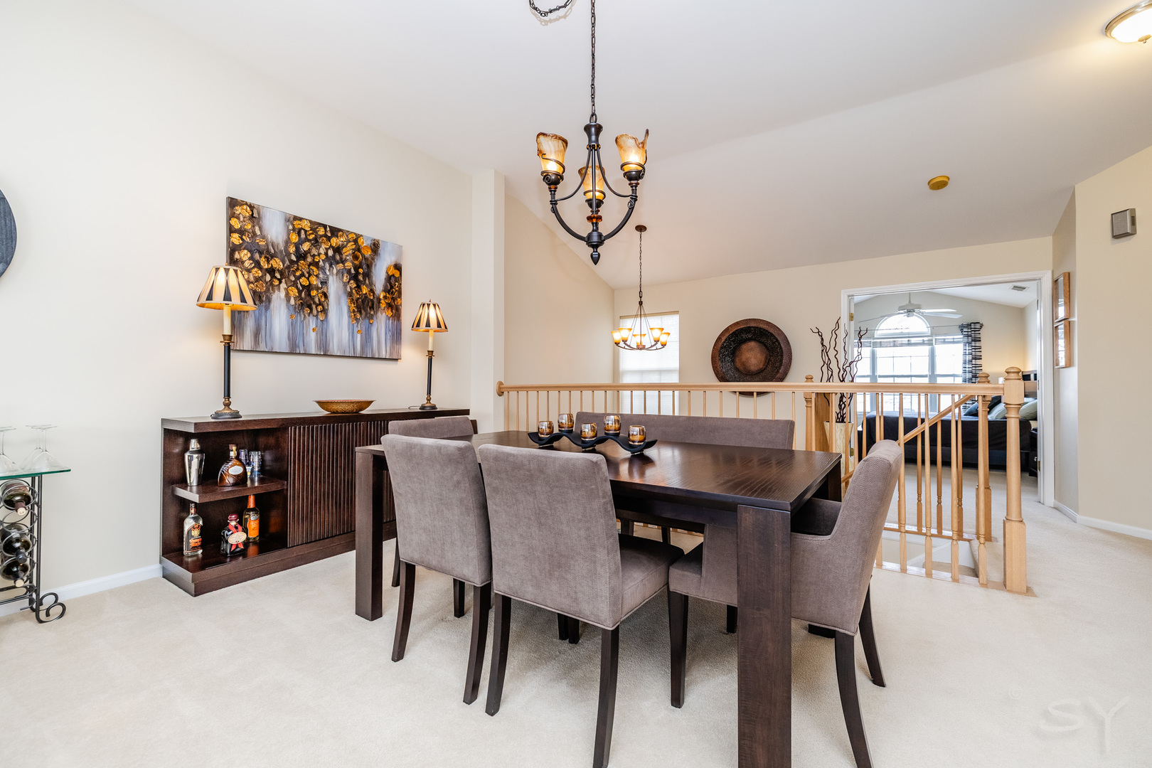 274 Wildspring Court Itasca, IL 60143 - Photo 8 of 42 a view of a dining room and livingroom with furniture wooden floor a rug a painting and a chandelier