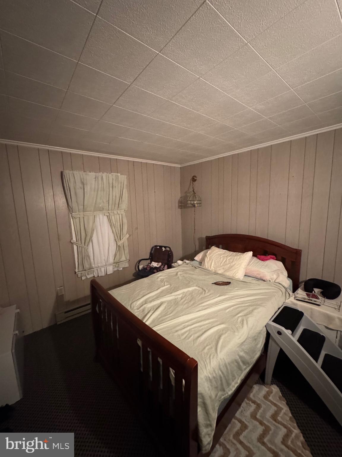 2728 Sandy Island Road Crapo, MD 21626 - Photo 8 of 15 a bed sitting in a bedroom next to a window