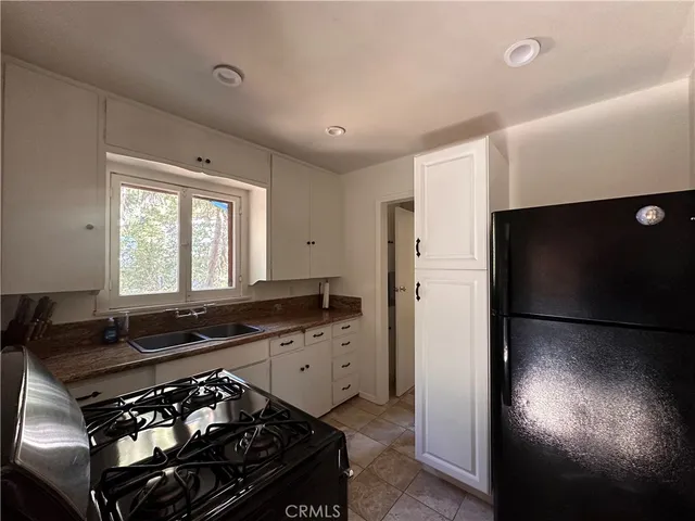 a kitchen with a stove and a window