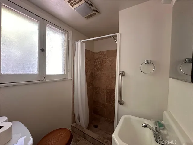 a bathroom with a toilet and shower