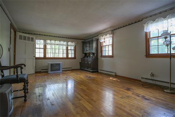 26 Gilson Road Littleton, MA 01460 - Photo 7 of 18 an empty room with wooden floor and windows