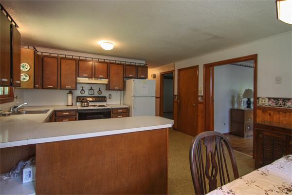 26 Gilson Road Littleton, MA 01460 - Photo 8 of 18 a kitchen with stainless steel appliances a refrigerator sink and wooden cabinets