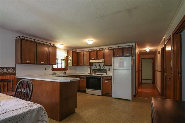 26 Gilson Road Littleton, MA 01460 - Photo 9 of 18 a kitchen with stainless steel appliances granite countertop a refrigerator a stove top oven a sink and dishwasher