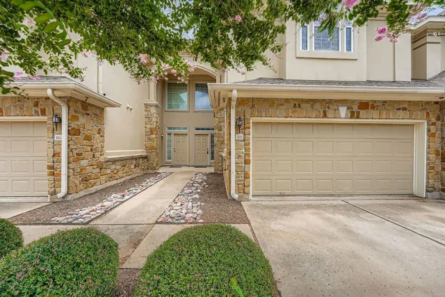 a front view of a house with a garage