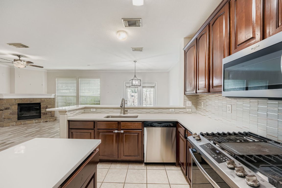 1101 East Parmer Lane, Unit 305 Austin, TX 78753 - Photo 13 of 37 a kitchen with a stove and a sink