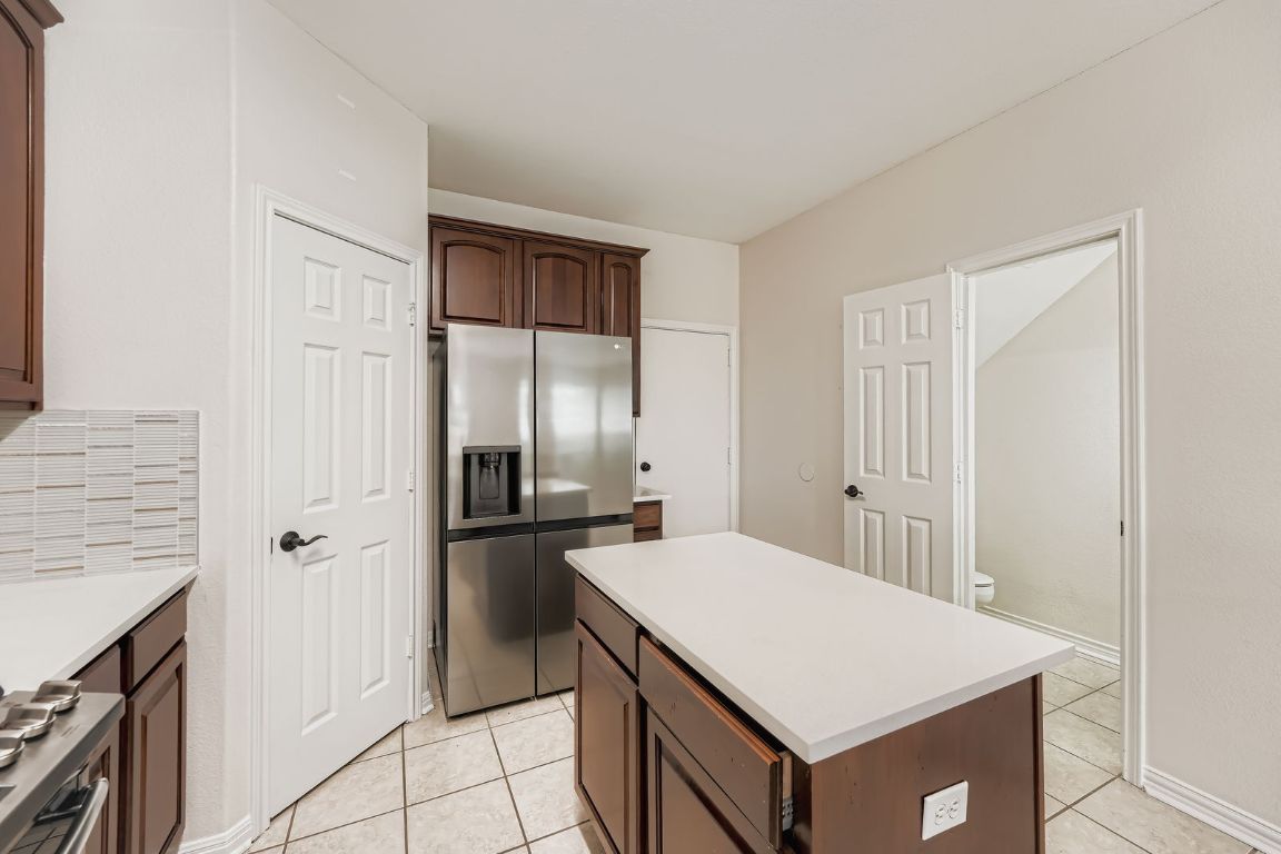 1101 East Parmer Lane, Unit 305 Austin, TX 78753 - Photo 14 of 37 a kitchen with stainless steel appliances a refrigerator and a stove