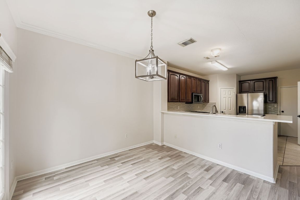 1101 East Parmer Lane, Unit 305 Austin, TX 78753 - Photo 16 of 37 a view of a room with wooden floor and a ceiling fan