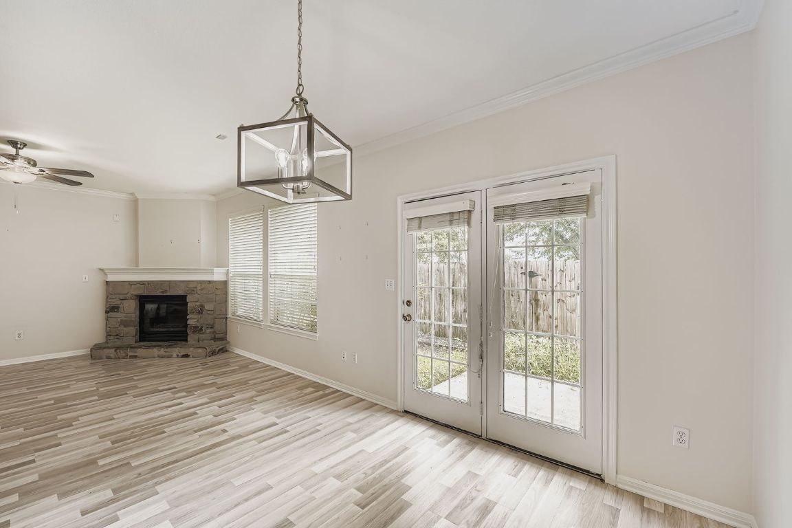1101 East Parmer Lane, Unit 305 Austin, TX 78753 - Photo 17 of 37 a view of an empty room with wooden floor fireplace and a window