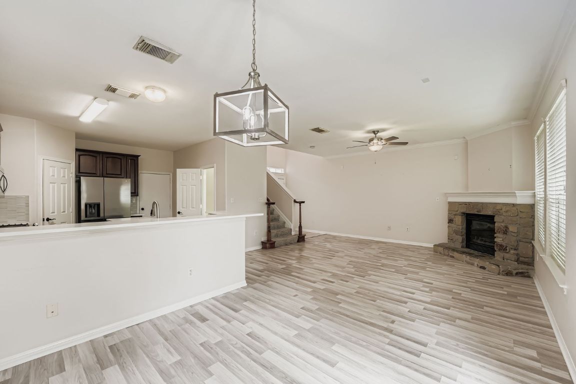 1101 East Parmer Lane, Unit 305 Austin, TX 78753 - Photo 18 of 37 a view of a livingroom with wooden floor and a ceiling fan