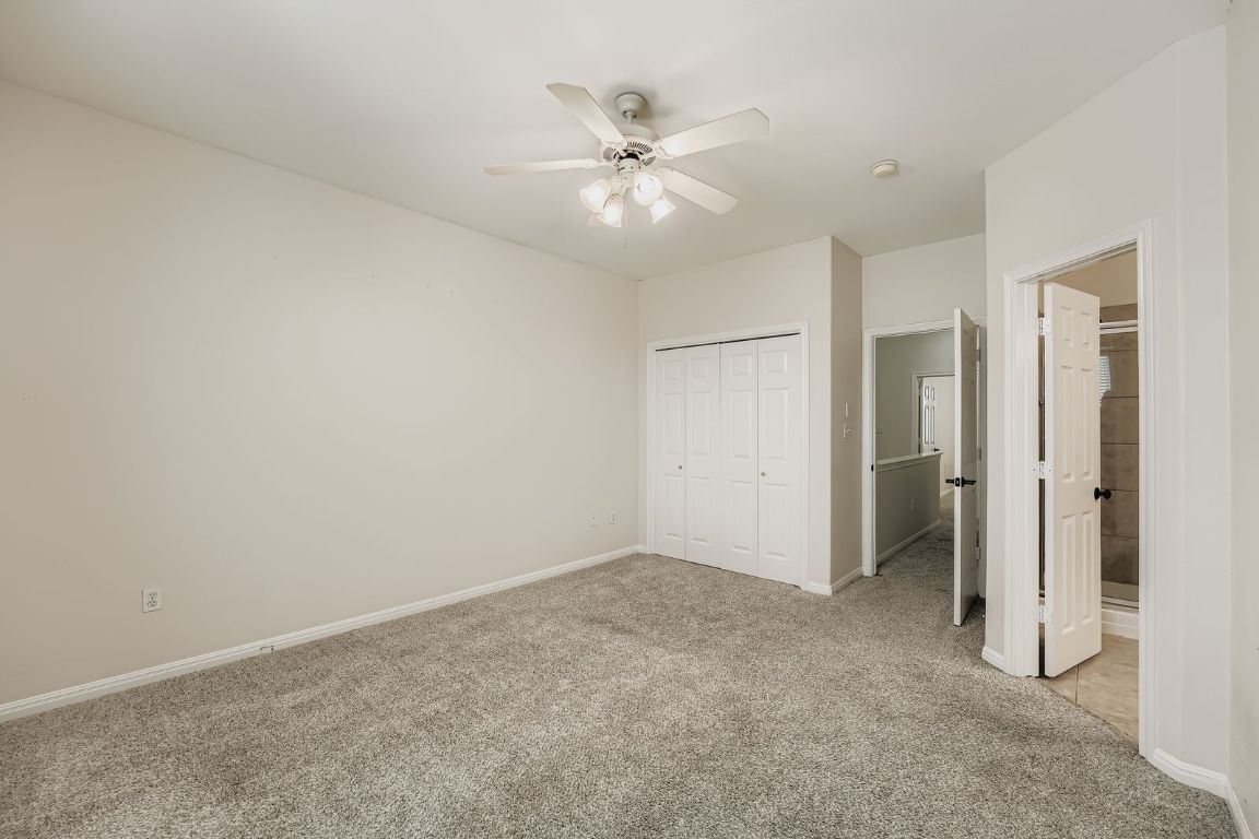 1101 East Parmer Lane, Unit 305 Austin, TX 78753 - Photo 24 of 37 a view of an empty room with a ceiling fan and closet