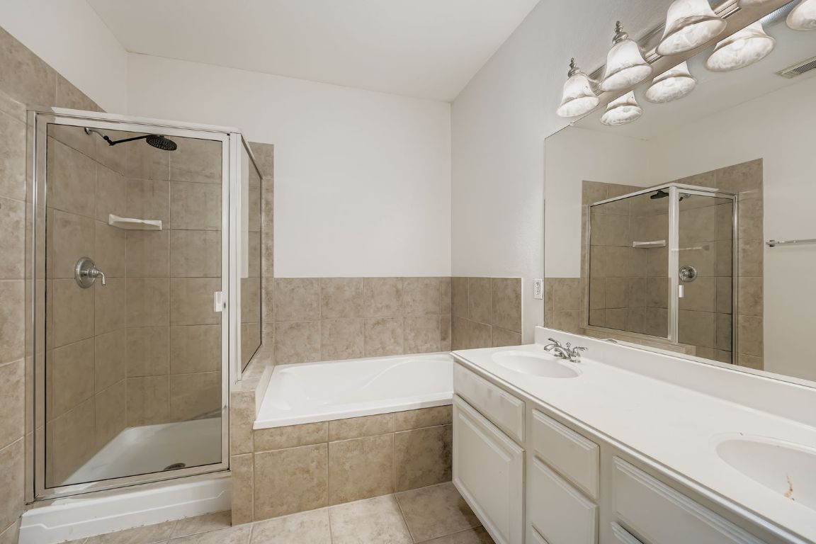 1101 East Parmer Lane, Unit 305 Austin, TX 78753 - Photo 27 of 37 a bathroom with a bathtub and a shower