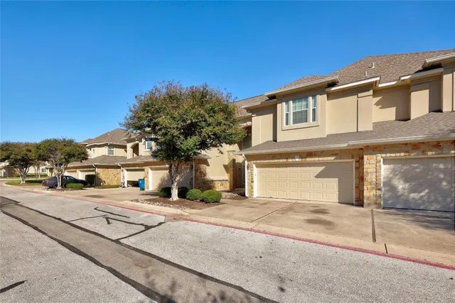 a view of livingroom with a fireplace a ceiling fan and wooden floor