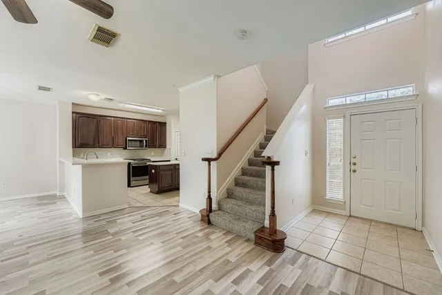 wooden floor fireplace and windows in an empty room