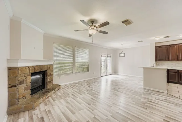 a view of empty room with wooden floor and fireplace