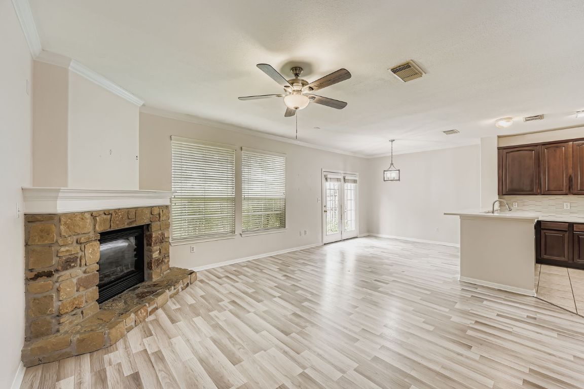 1101 East Parmer Lane, Unit 305 Austin, TX 78753 - Photo 7 of 37 a view of livingroom with a fireplace a ceiling fan and wooden floor