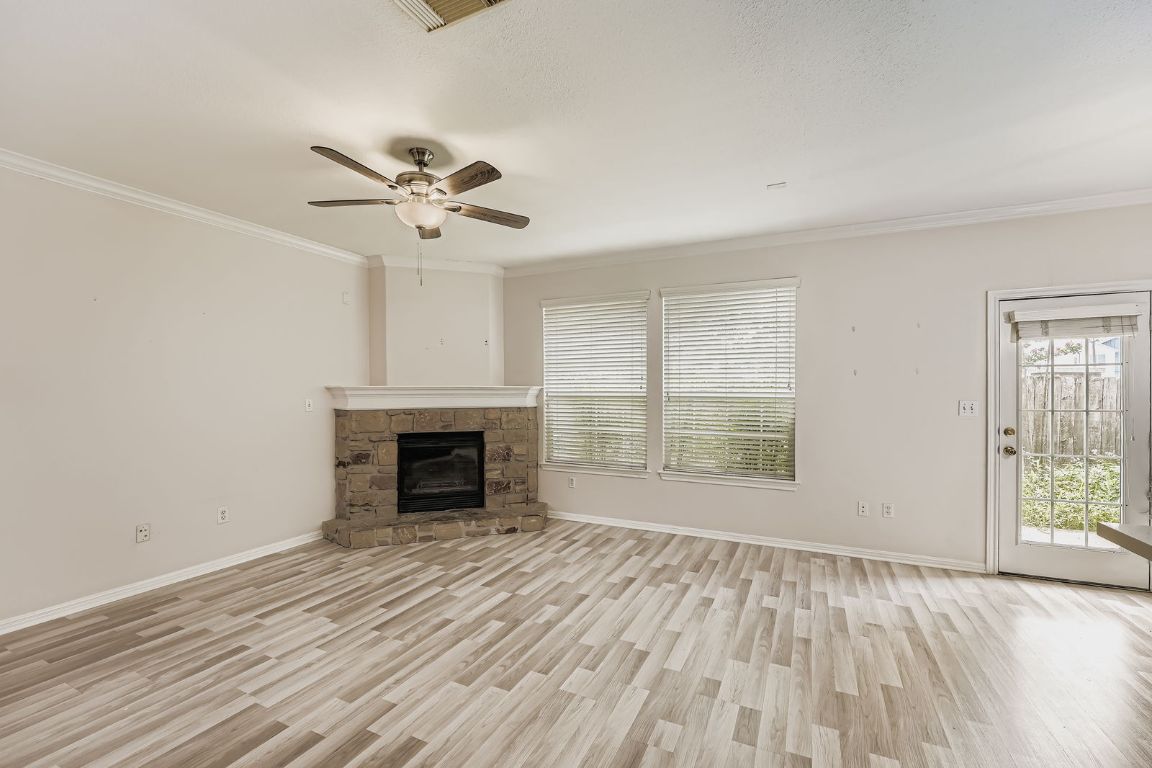 1101 East Parmer Lane, Unit 305 Austin, TX 78753 - Photo 8 of 37 wooden floor fireplace and windows in an empty room