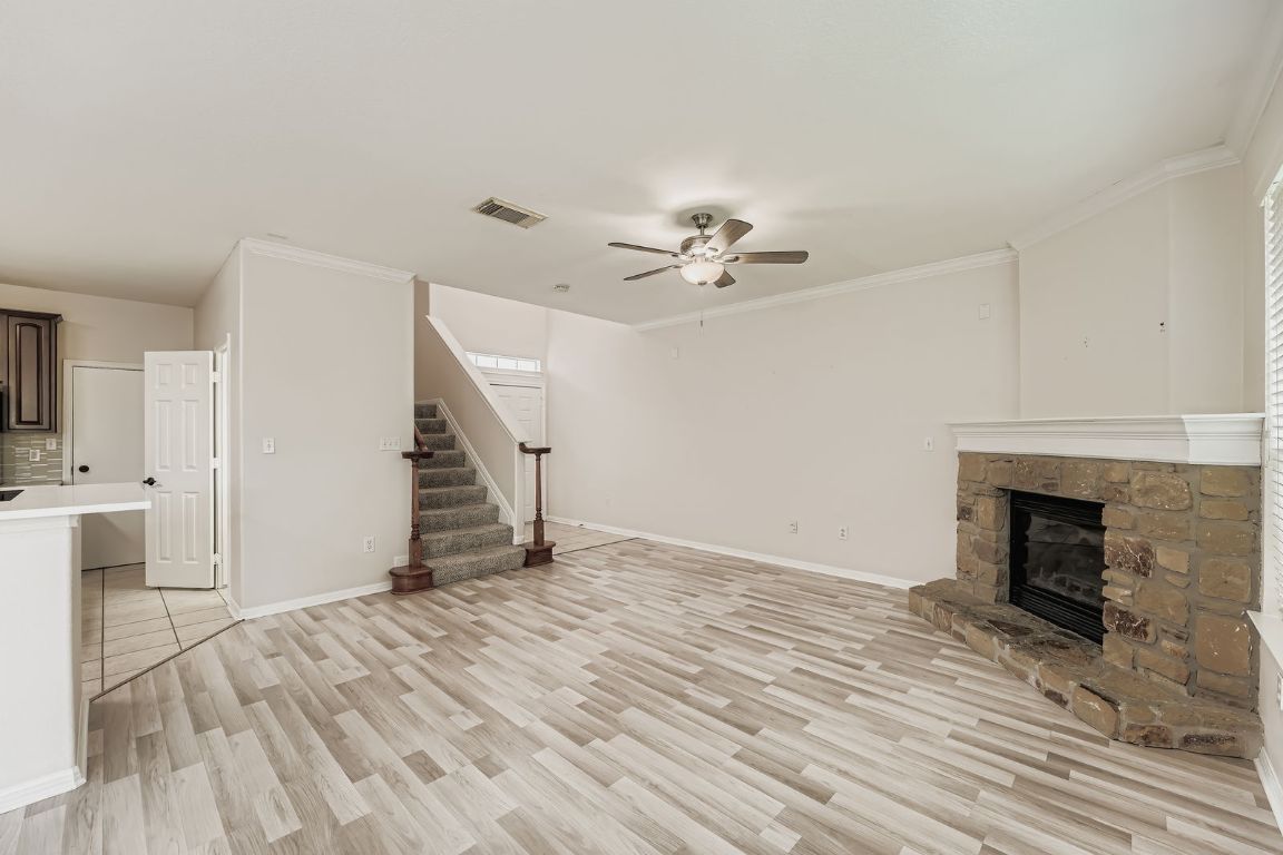 1101 East Parmer Lane, Unit 305 Austin, TX 78753 - Photo 9 of 37 a view of empty room with wooden floor and fireplace