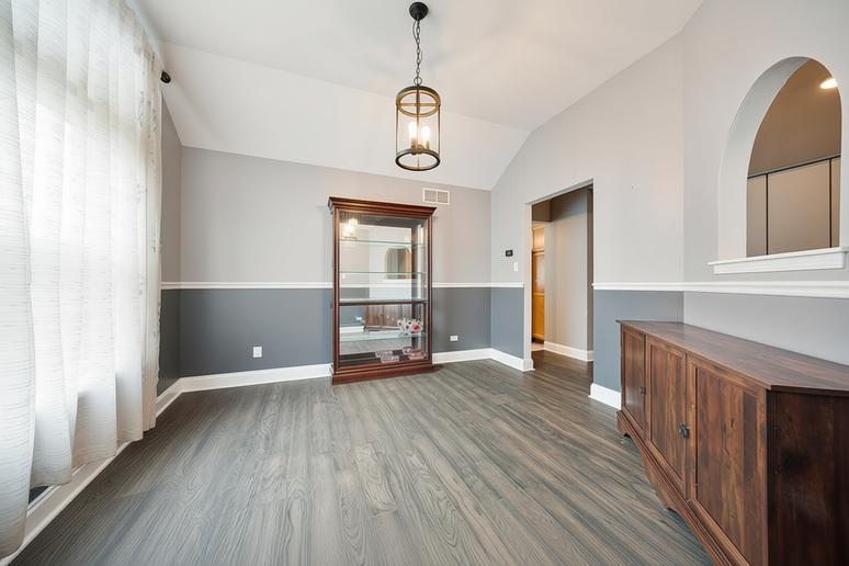 1014 Edinburgh Court Joliet, IL 60431 - Photo 9 of 25 an empty room with wooden floor and windows