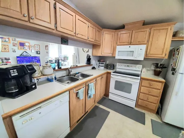 a kitchen with a white cabinets and white appliances
