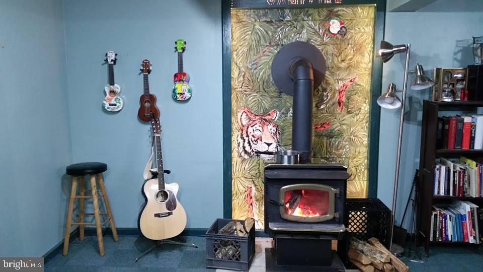 2038 North Blue Bell Road Newfield, NJ 08344 - Photo 16 of 21 Wood stove and mural on wall
