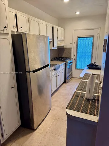 a kitchen with a refrigerator stove and sink