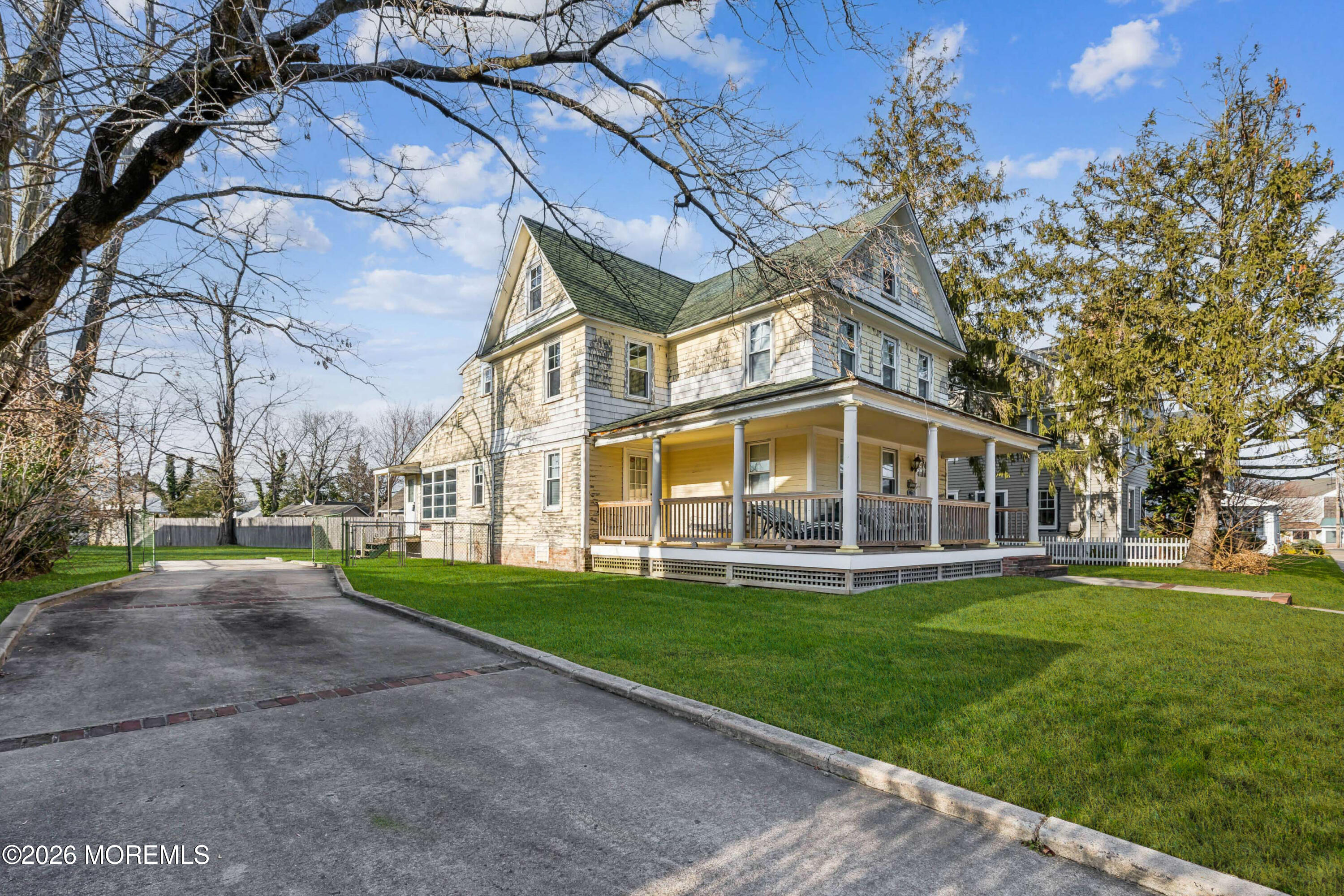909 Arnold Avenue Point Pleasant, NJ 08742 - Photo 4 of 36 a view of a big house with a big yard and large trees