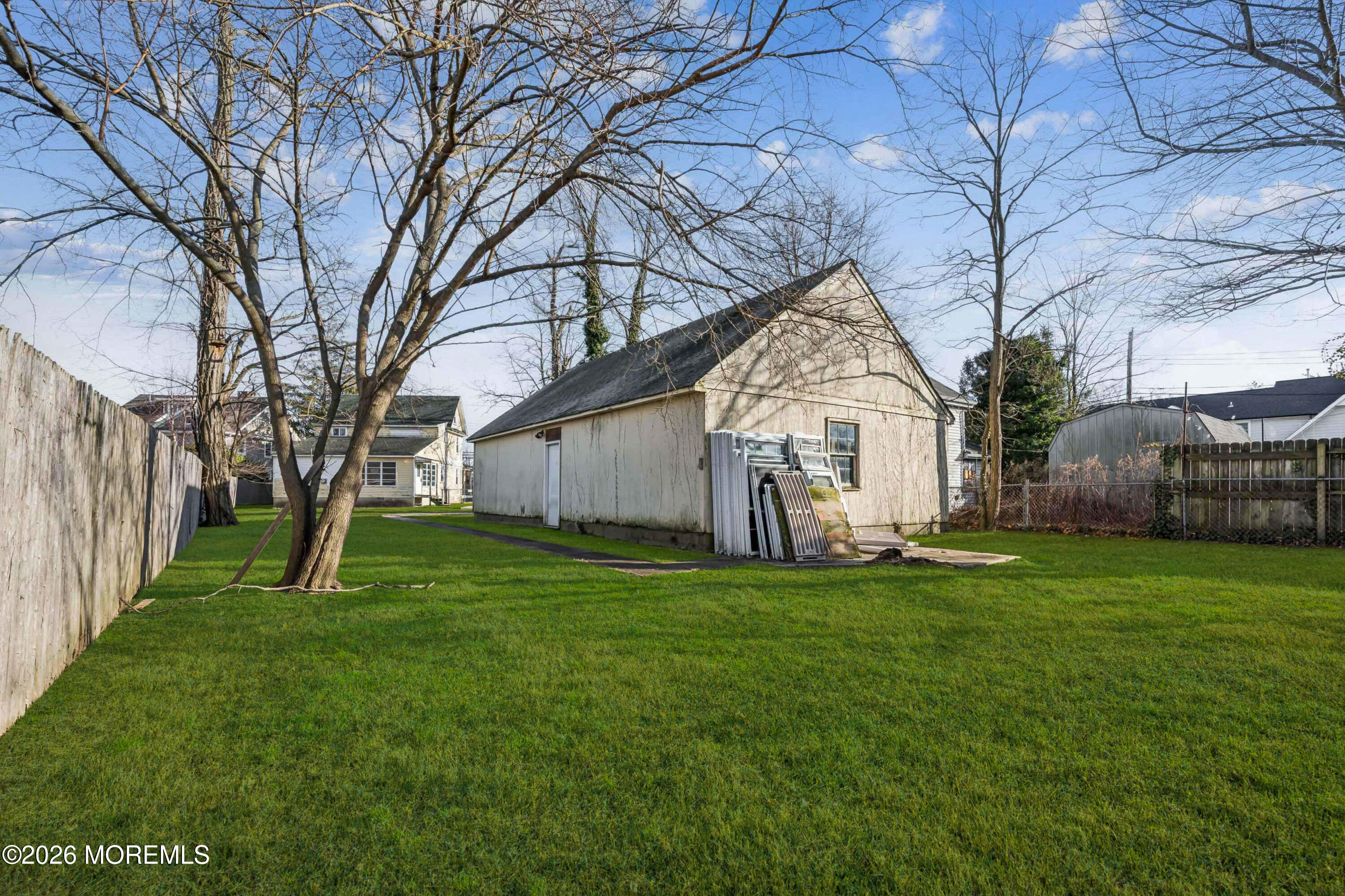 909 Arnold Avenue Point Pleasant, NJ 08742 - Photo 10 of 36 a big white house with a big yard and large trees