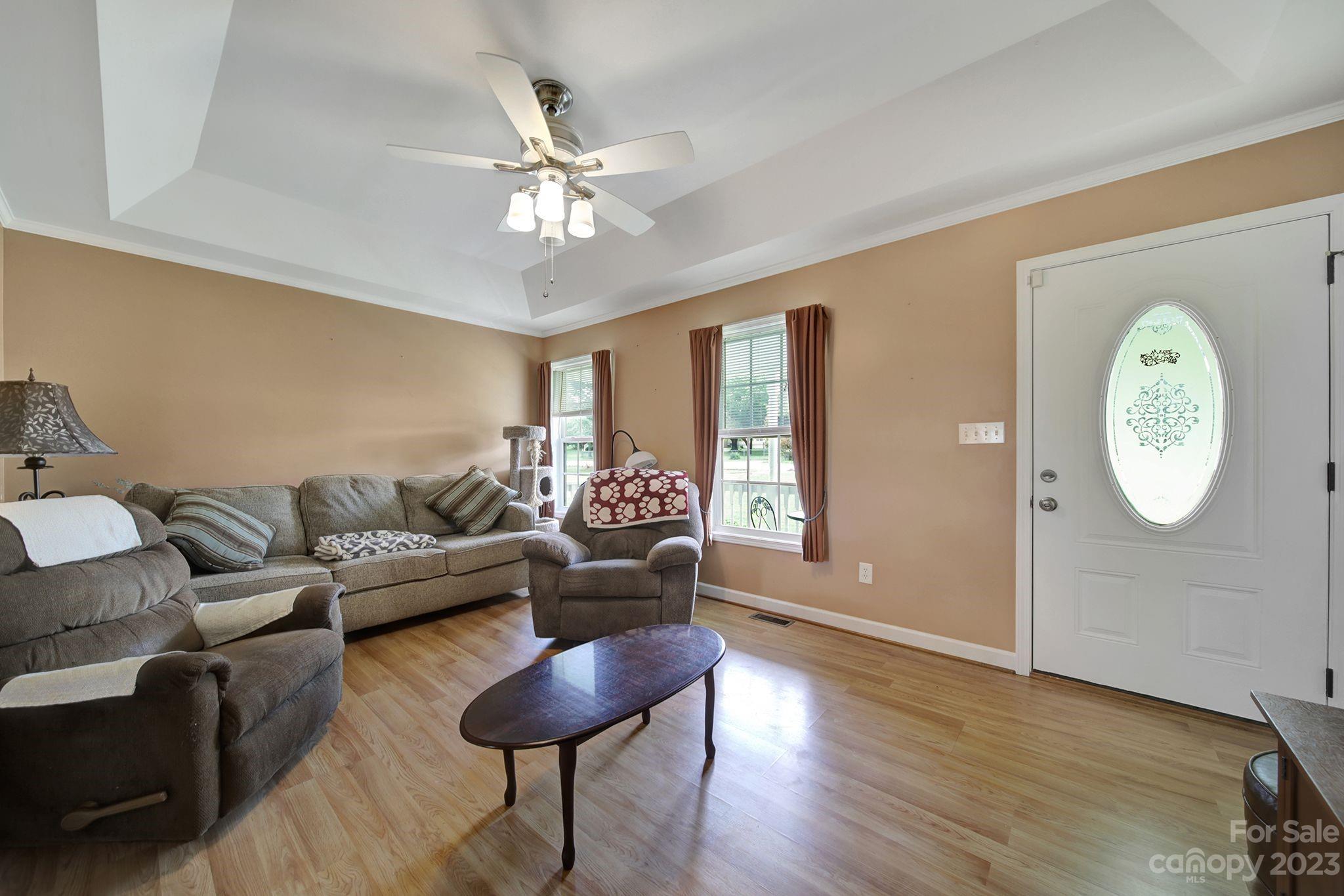 2674 State Rd S-29-330 Lancaster, SC 29720 - Photo 3 of 25 a living room with furniture a clock on wall and a window