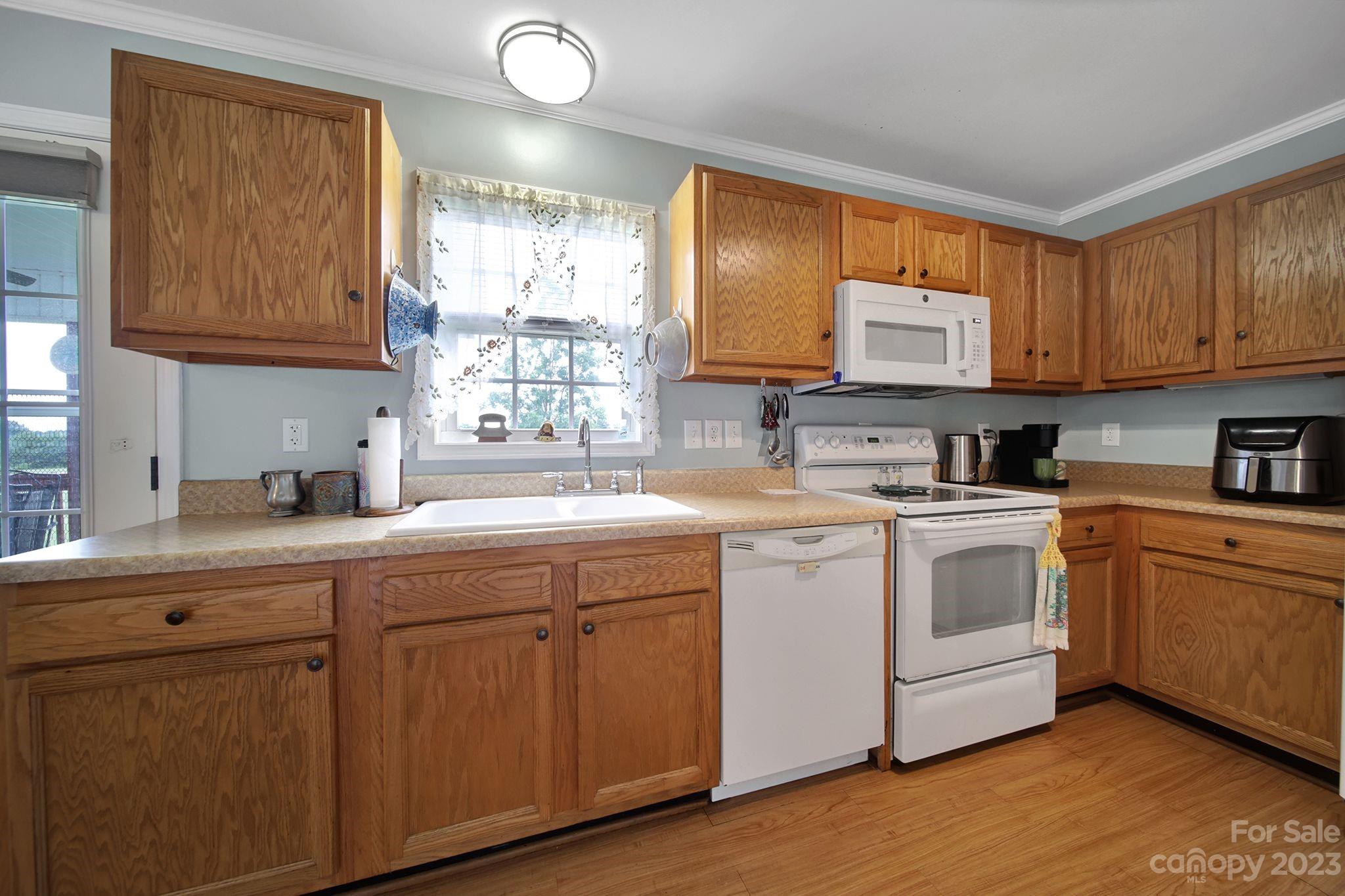 2674 State Rd S-29-330 Lancaster, SC 29720 - Photo 8 of 25 a kitchen with cabinets appliances a sink and a counter top space