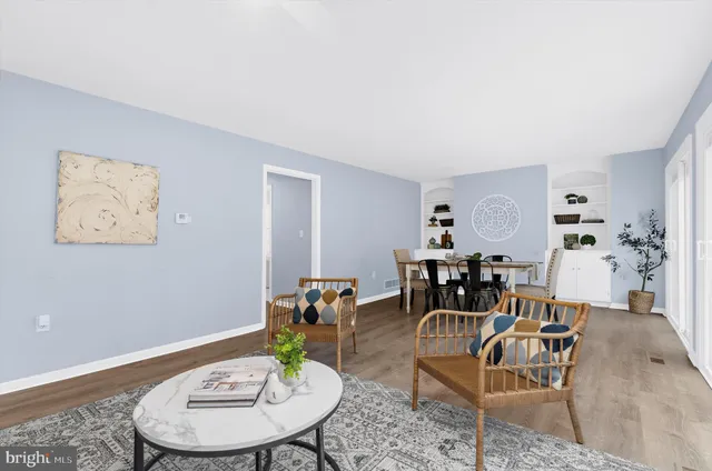 a dining room with furniture and wooden floor