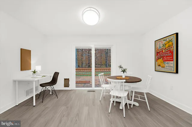 a dining room with furniture and wooden floor