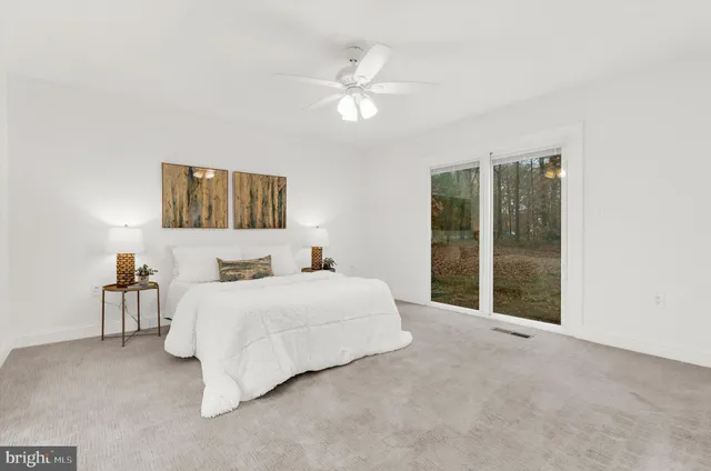 a bedroom with a bed and a large mirror