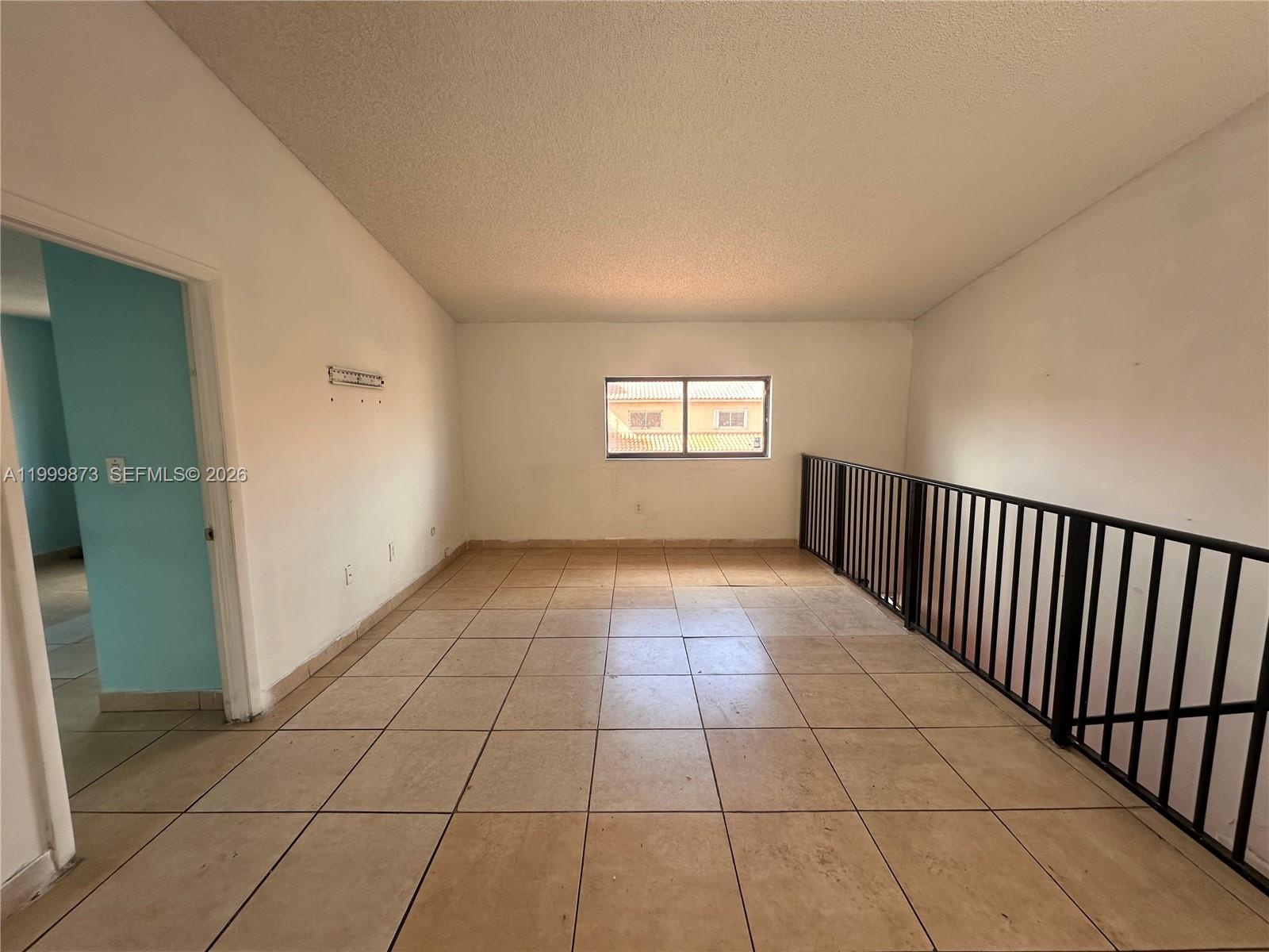 7952 West 29th Way, Unit 202 Hialeah, FL 33018 - Photo 1 of 12 a view of an empty room and window
