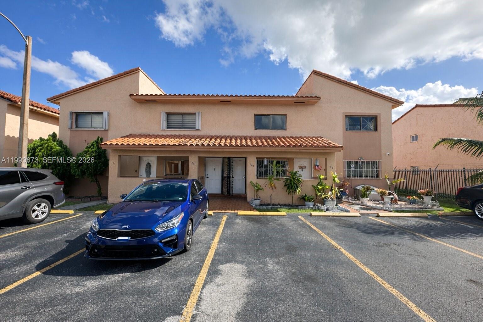 7952 West 29th Way, Unit 202 Hialeah, FL 33018 - Photo 11 of 12 a front view of a house with a garden