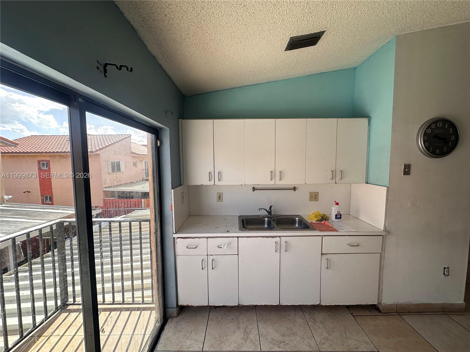 7952 West 29th Way, Unit 202 Hialeah, FL 33018 - Photo 4 of 12 a kitchen with a sink and cabinets