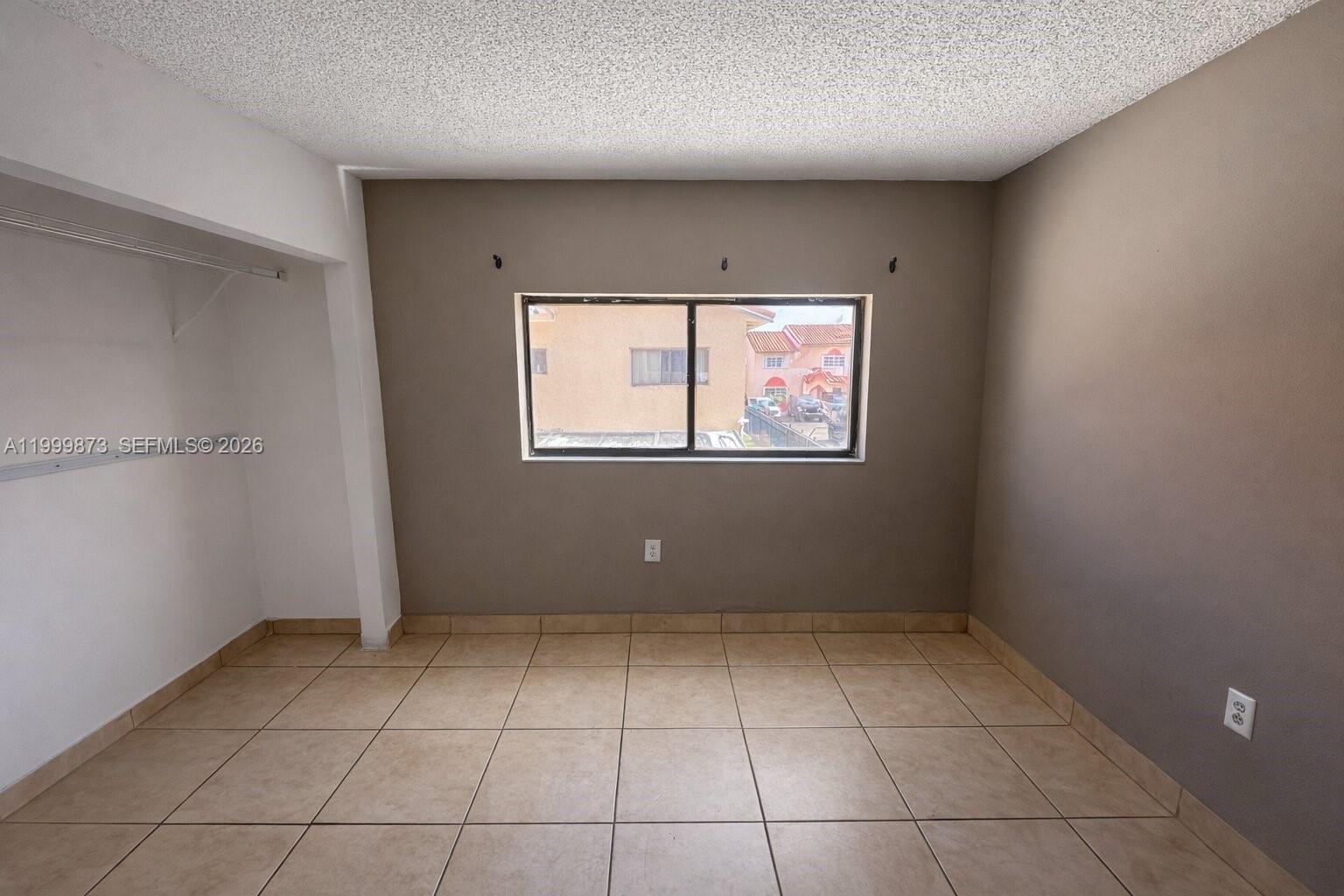 7952 West 29th Way, Unit 202 Hialeah, FL 33018 - Photo 6 of 12 an empty room with windows