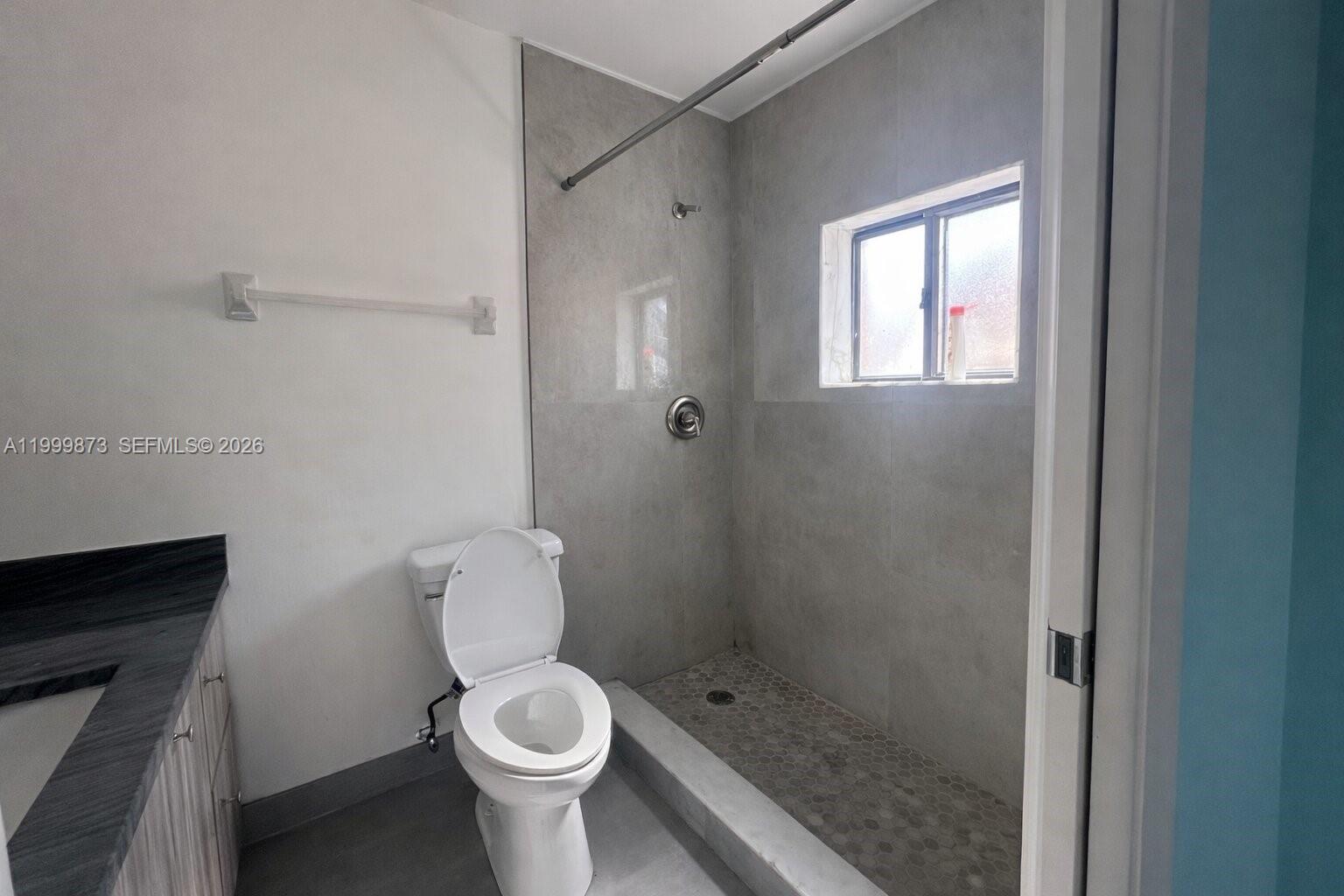 7952 West 29th Way, Unit 202 Hialeah, FL 33018 - Photo 10 of 12 a white toilet sitting next to a bathroom sink