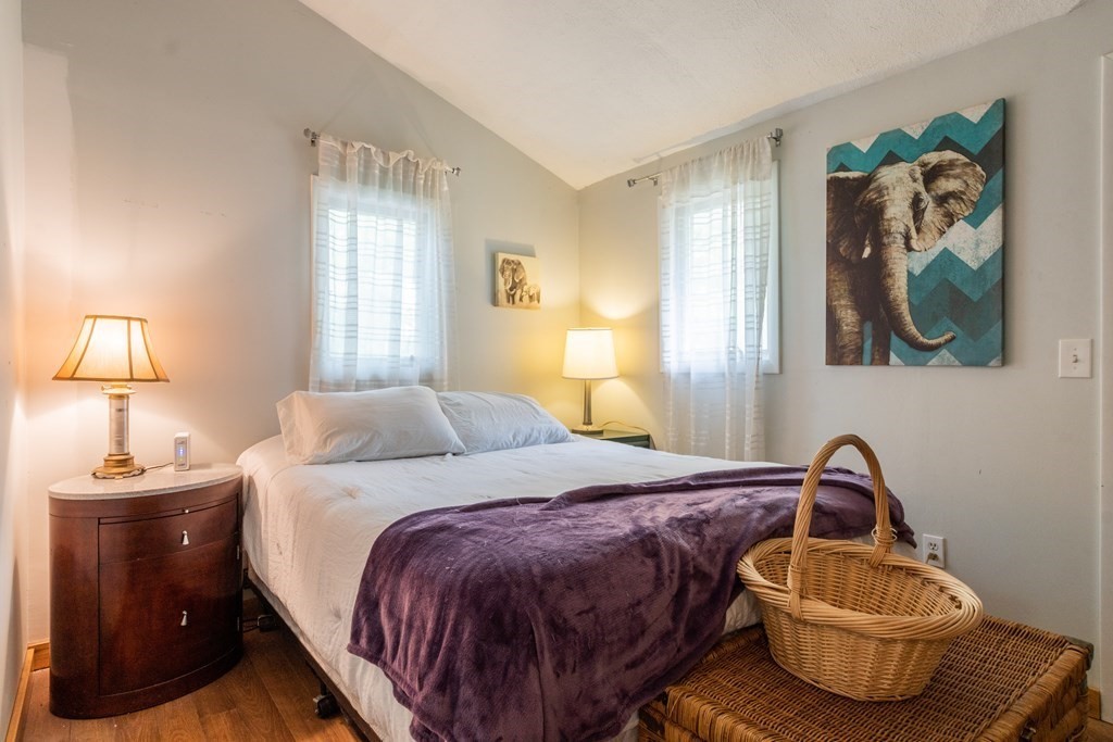 7 Sunset Drive Merrimack, NH 03054 - Photo 15 of 35 a bedroom with a bed and lamp