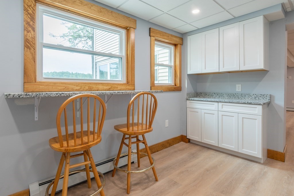 7 Sunset Drive Merrimack, NH 03054 - Photo 20 of 35 a view of a kitchen with furniture and wooden floor