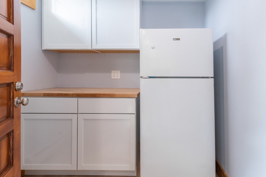7 Sunset Drive Merrimack, NH 03054 - Photo 22 of 35 a white refrigerator freezer sitting inside of a kitchen