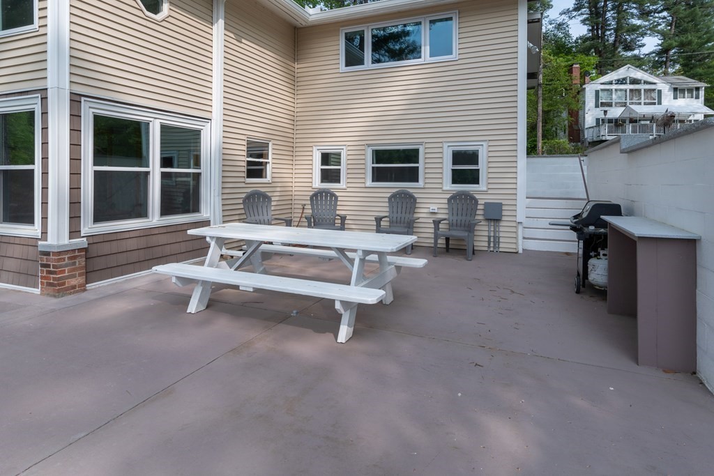 7 Sunset Drive Merrimack, NH 03054 - Photo 30 of 35 a view of a patio with a table and chairs