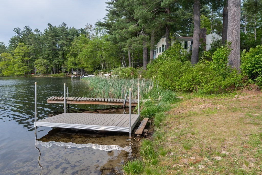7 Sunset Drive Merrimack, NH 03054 - Photo 32 of 35 a view of a wooden deck with chairs and a yard