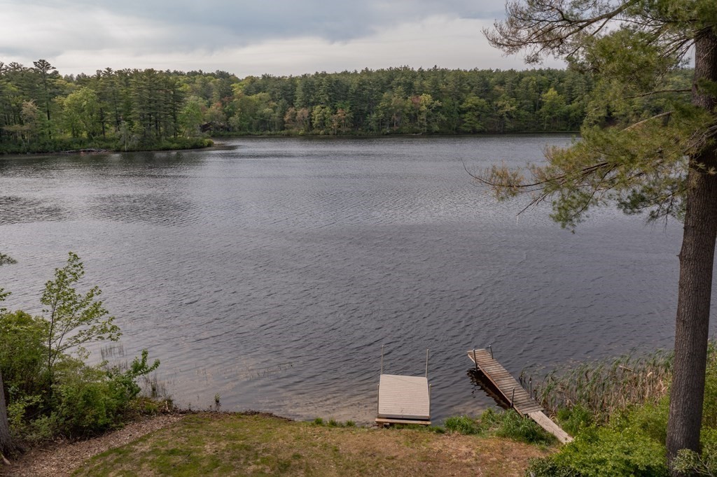 7 Sunset Drive Merrimack, NH 03054 - Photo 4 of 35 a view of a lake with trees in the background