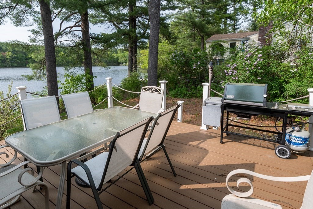 7 Sunset Drive Merrimack, NH 03054 - Photo 5 of 35 a view of a patio with a table chairs and a grill