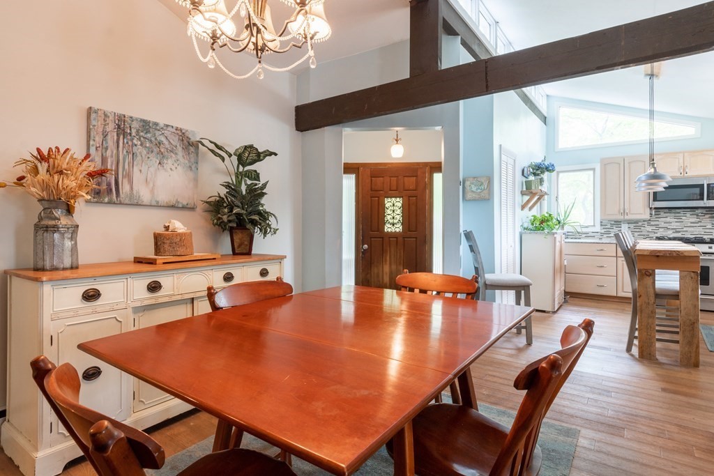 7 Sunset Drive Merrimack, NH 03054 - Photo 7 of 35 a dining room with furniture a chandelier and wooden floor